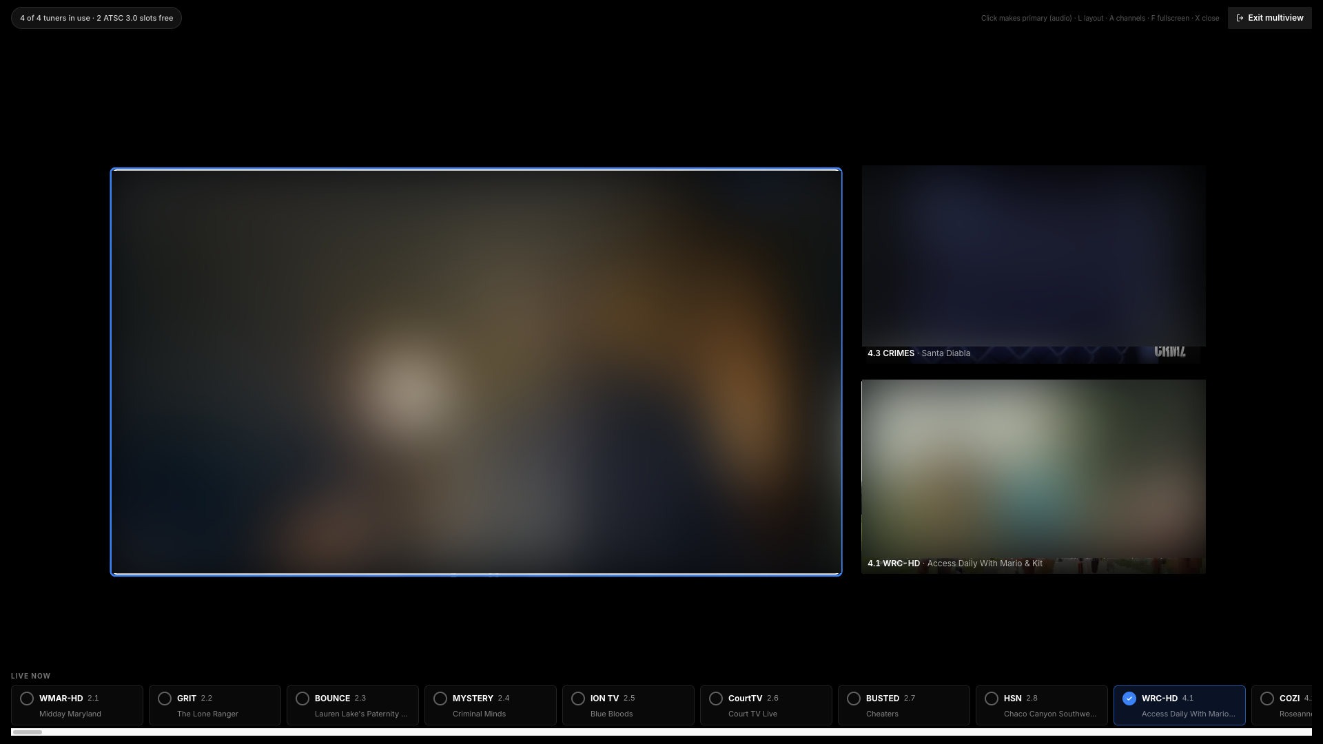 Multiview in an L layout: one large channel holding audio focus, two smaller channels stacked beside it, and the live-now channel strip along the bottom