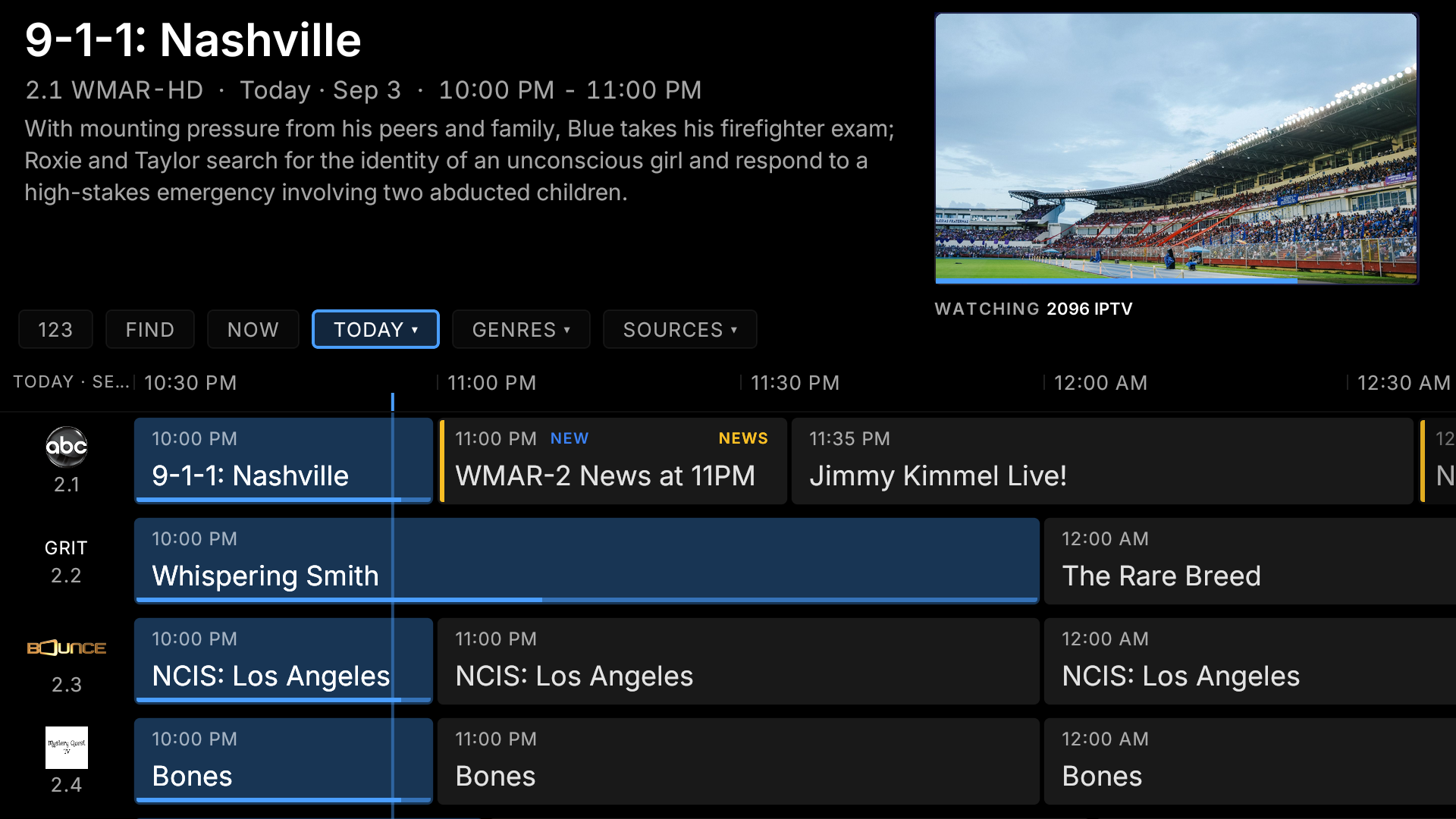 The TIBBL guide on Fire TV: a programme grid over a solid background, with channel artwork and a live preview in the top corner